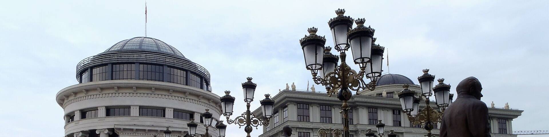 A bridge with statues and ornate street lamps.