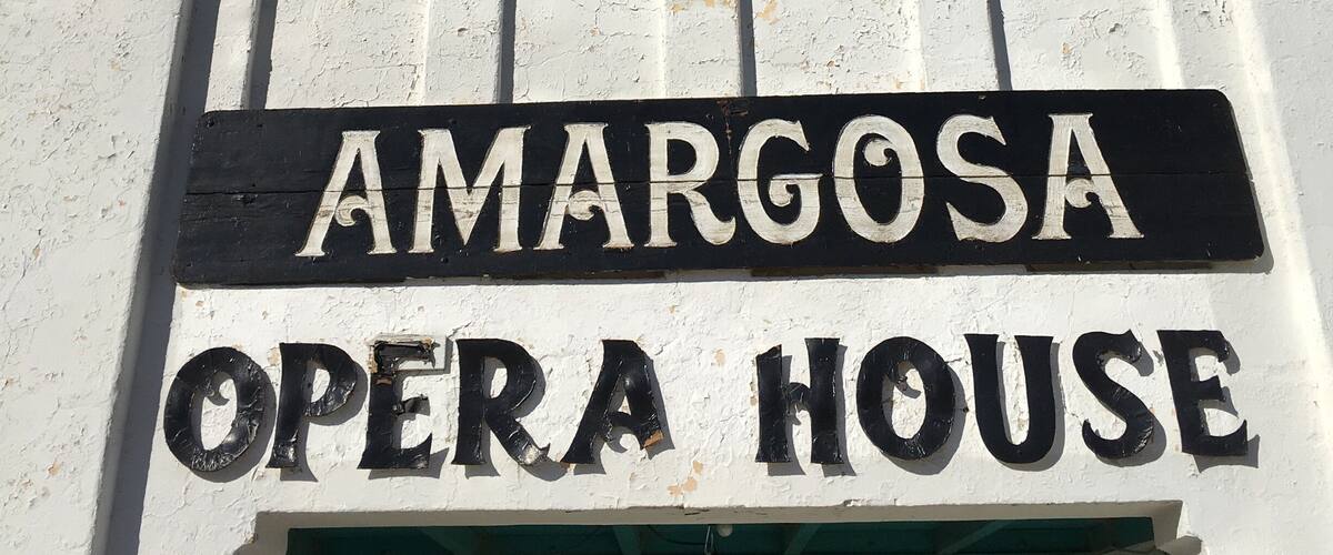 A sign for Amargosa Opera House with decorative tiles above it.