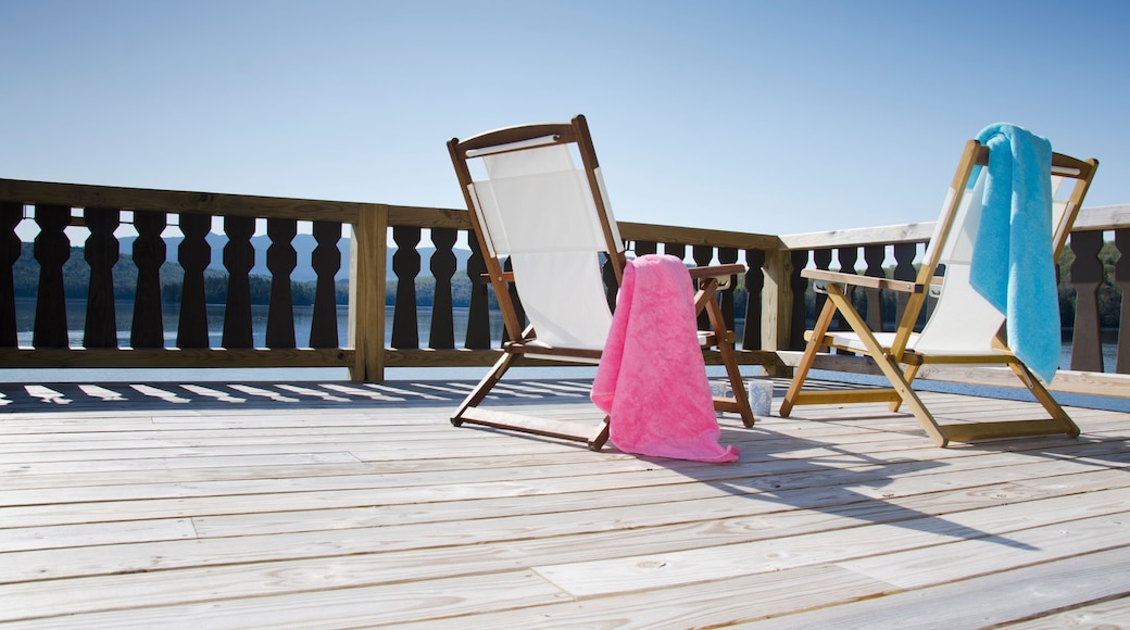 USA, New York, Lake Placid, Canvas chairs on deck overlooking lake