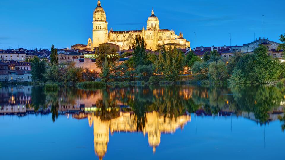 The Cathedral of Salamanca and the river Tormes at night