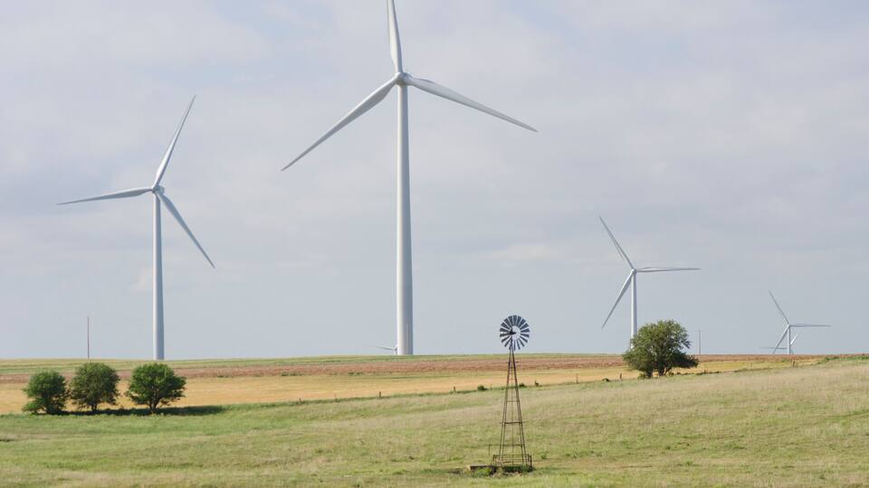 Old and New Wind Turbine on a Wind Farm