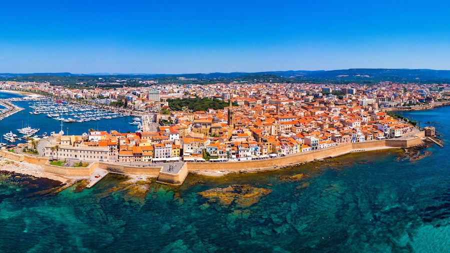Aerial view over Alghero old town, cityscape Alghero view on a beautiful day with harbor and open sea in view. Alghero, Italy. Panoramic aerial view of Alghero, Sardinia, Italy.
