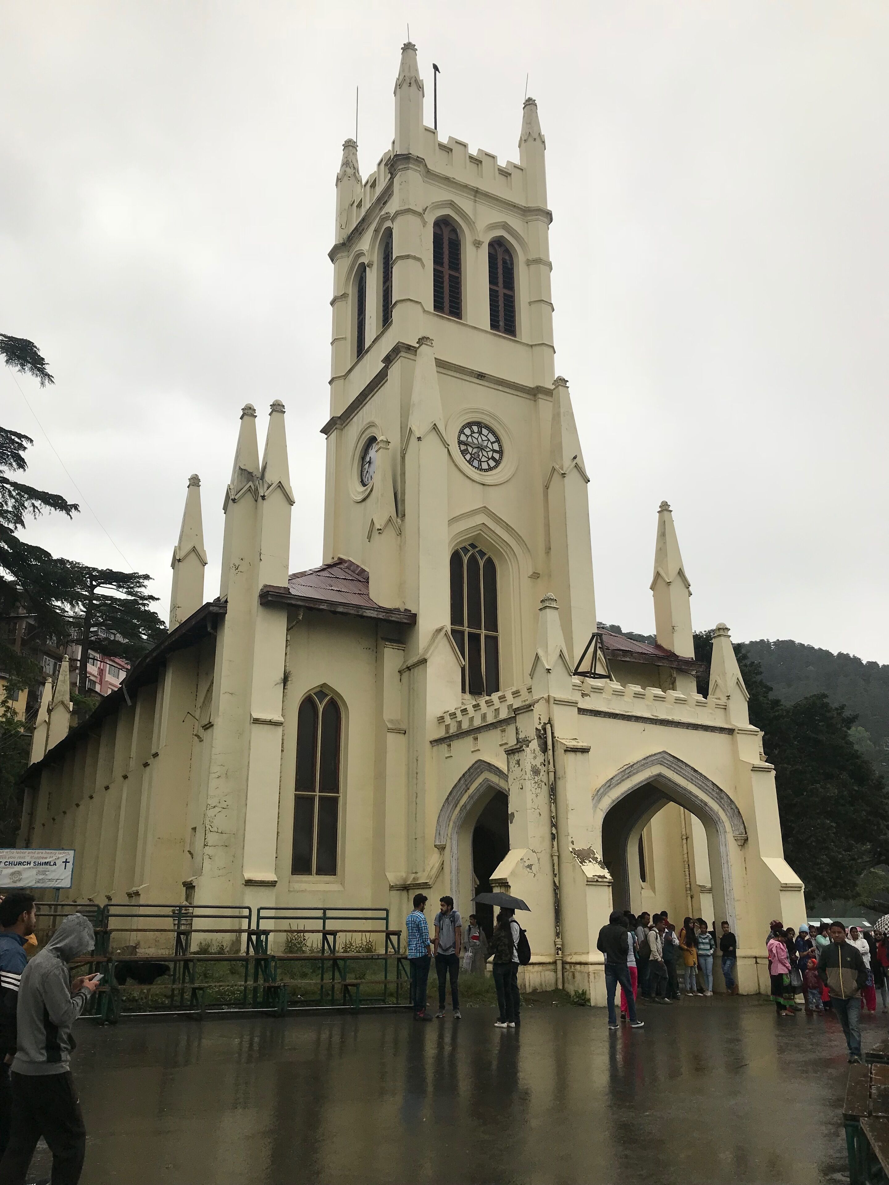 A historic church with a tall bell tower and arched windows.