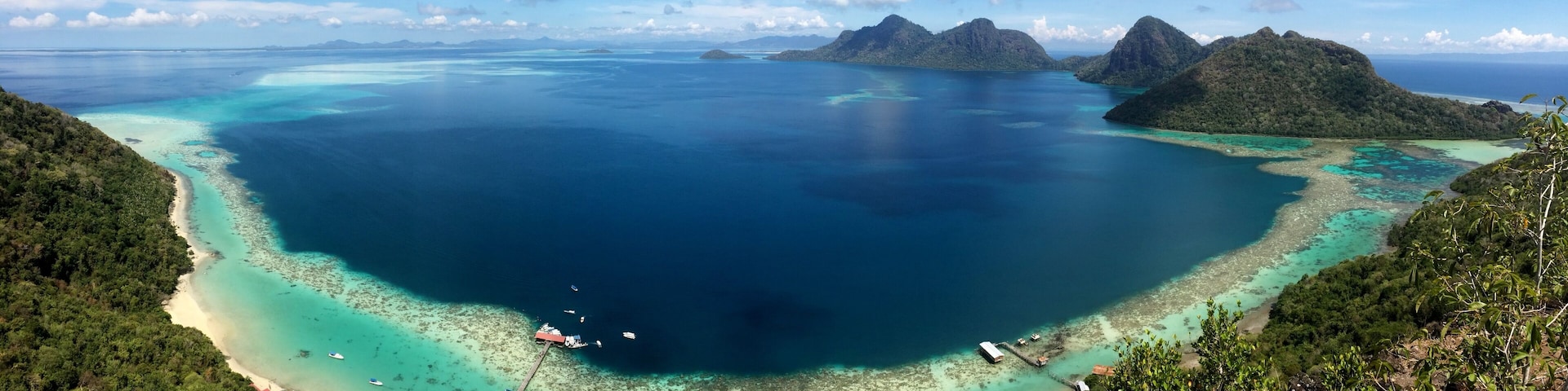 Ask a boatman at the Semporna dock to bring you to Bohey Dulang. From the jetty it is a short but sweaty hike to this viewpoint. The waters down here in the Tun Sakaran marine park are excellent for snorkling and cooling down after your hike :-)