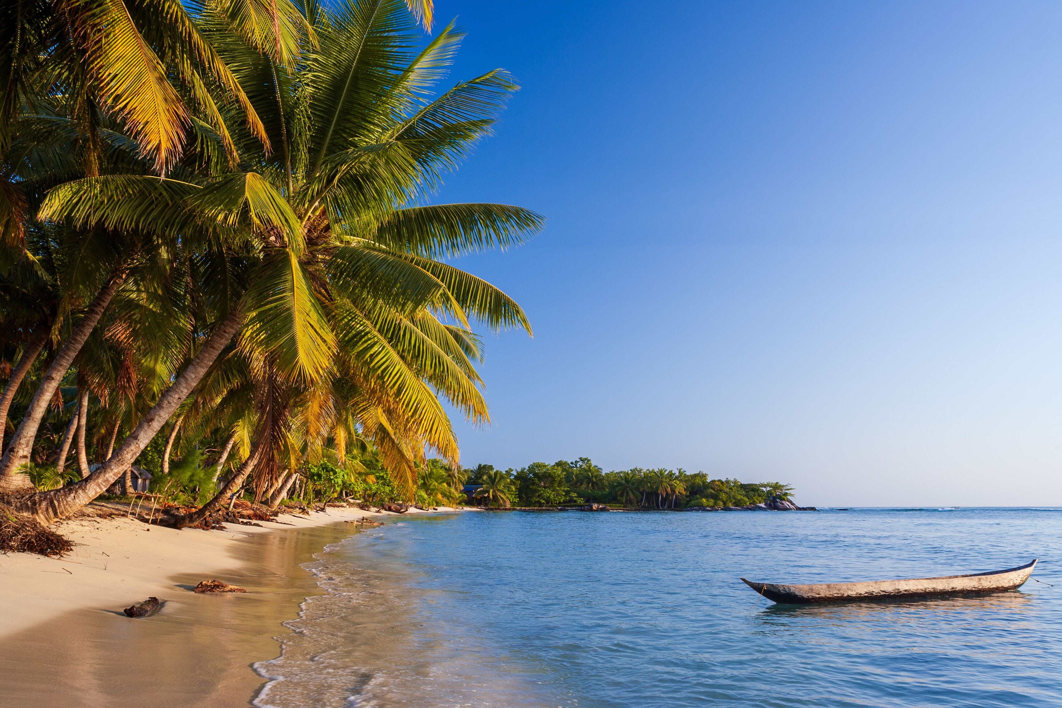 Beach and traditional fishing pirogue, ile aux Nattes (Sainte Marie), Madagascar.