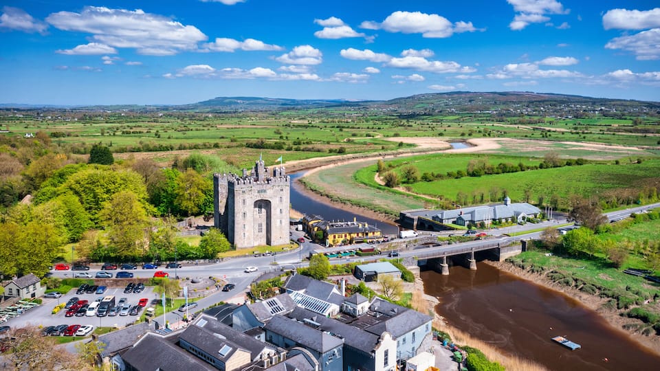 A castle, a river, a bridge, and a parking lot.