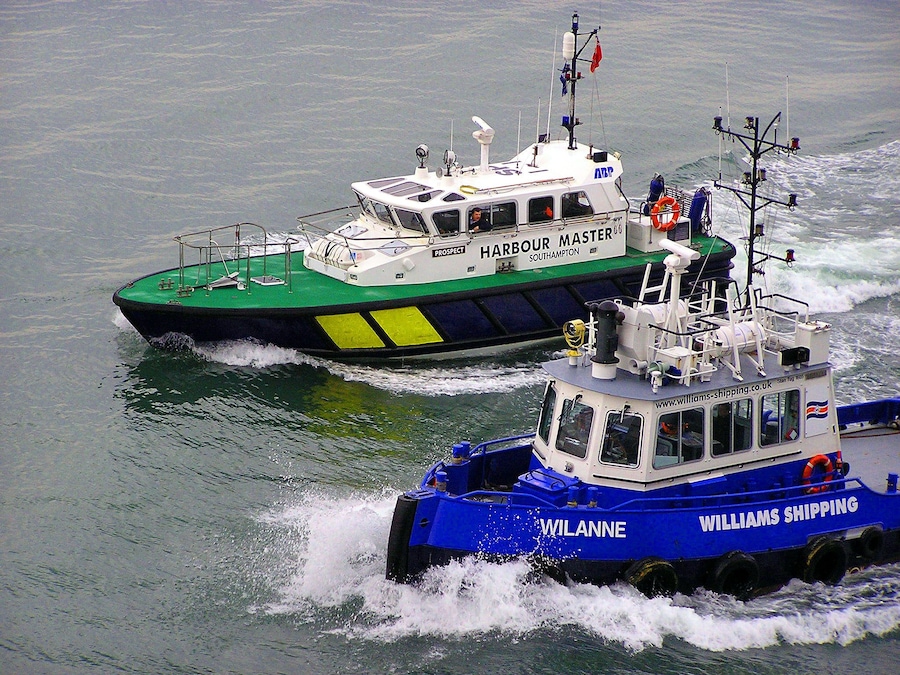 Two boats, one named 'Harbour Master' and the other 'Wilanne', on a body of water.