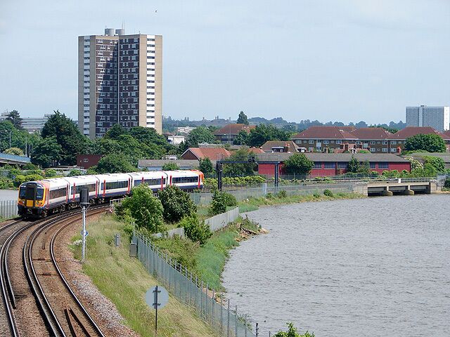 Crossing the River Test A Waterloo bound "fast" service leans into the curve across the River Test as it approaches Redbridge. The 1960's Redbridge Tower flats dominates the skyline.