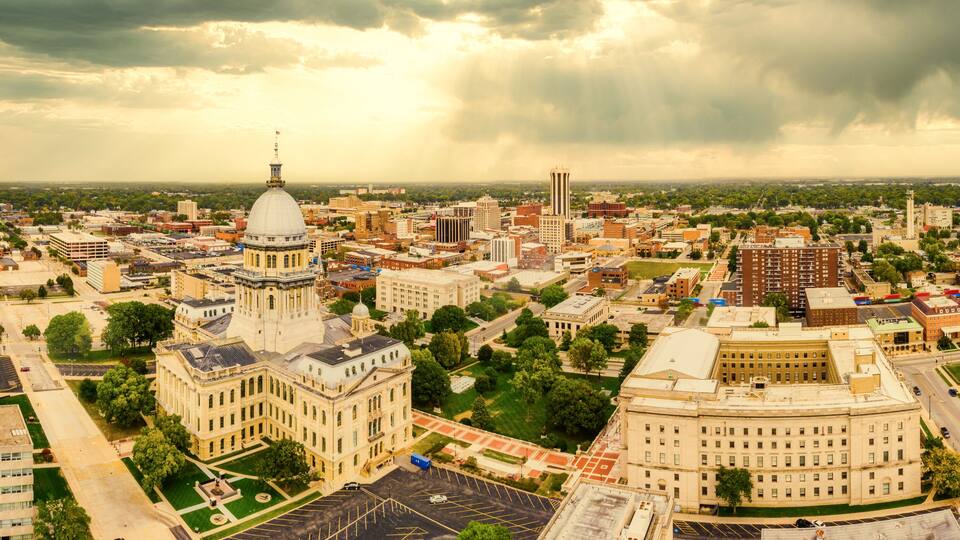Aerial panorama of the Illinois State Capitol dome and Springfield skyline under a dramatic sunset. Springfield is the capital of the U.S. state of Illinois and the county seat of Sangamon County