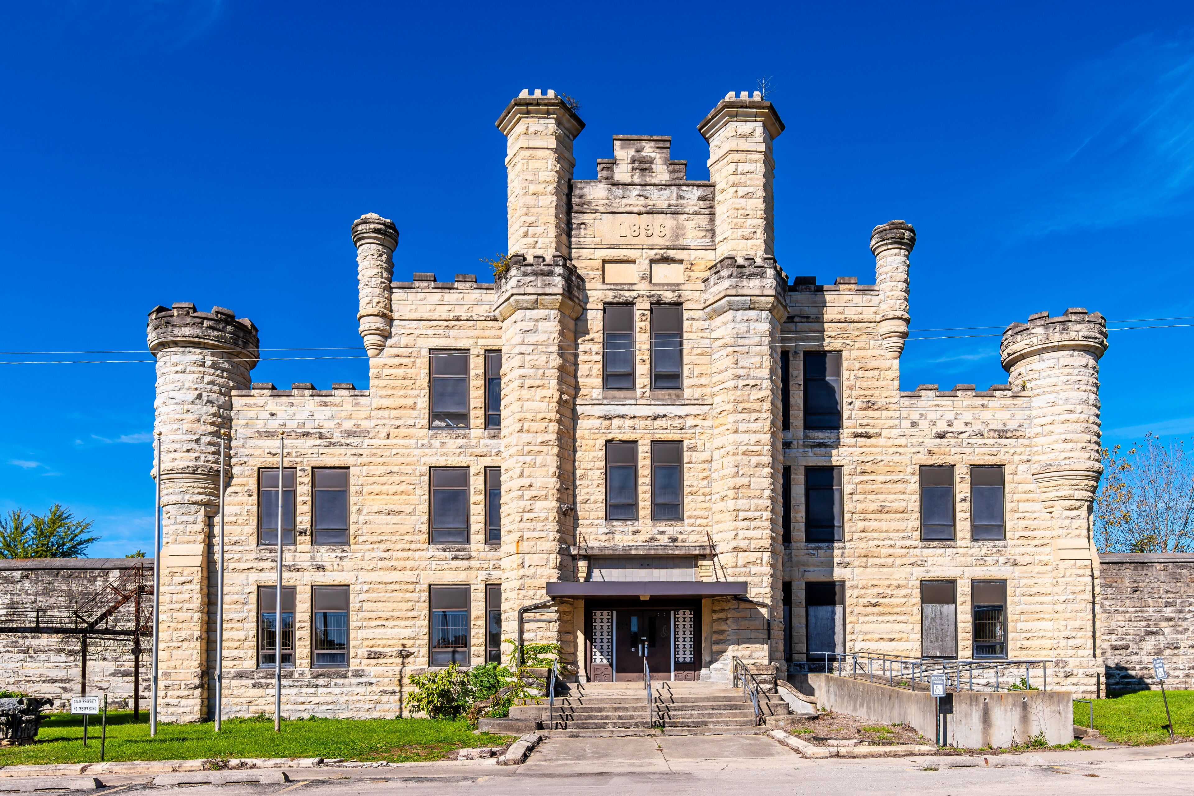 A large stone building with a central tower and two smaller towers on either side.
