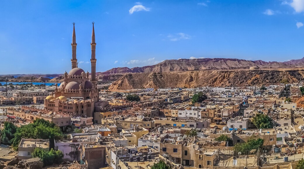 Widescreen panorama of the Old Market in Sharm El Sheikh with the Al Sahaba Mosque in the center and the Red Sea on the horizon. Aerial view of an Egyptian resort