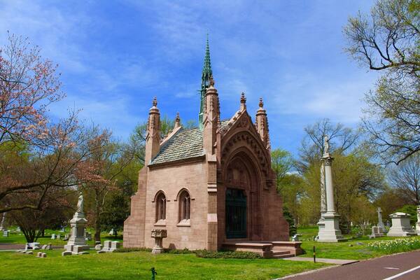 Bellefontaine Cemetery is a nonprofit, non-denominational cemetery and arboretum located in St. Louis, Missouri. Founded in 1849 as a rural cemetery, Bellefontaine is home to a number of architecturally significant monuments and mausoleums such as the Louis Sullivan-designed Wainwright Tomb, which is listed on the National Register of Historic Places. The cemetery contains 314 acres of land and over 87,000 graves, including those of William Clark, Adolphus Busch, Thomas Hart Benton, and William S. Burroughs. Many Union and Confederate soldiers from the American Civil War are buried at Bellefontaine, as well as numerous local and state politicians.
As of 2012 over 87,000 people have been buried at Bellefontaine Cemetery, and approximately 100 new burials take place each year. Bellefontaine remains a non-profit, non-denominational cemetery, and still holds over 100 acres of open, unused land. Some of this extra land has recently been converted into prairie and woodland. Bellefontaine contains over 14 miles of paved roads and, as an accredited arboretum, is home to over 180 species of trees and shrubs. A new lakeside garden and columbarium were completed in 2010, and other major landscaping projects are planned or in progress.
The cemetery contains the graves of many prominent pioneers to the West, as well as businessmen, politicians, and generals who remain significant figures in the history of St. Louis and the United States. The oldest graves in the cemetery are located on pioneer Edward Hempstead’s family lot and date as far back as 1816. Many of the wealthiest families at Bellefontaine are interred in ornate mausoleums which overlook the Mississippi River and draw from Classical, Romanesque, Gothic, and Egyptian architectural styles. Among the most notable mausoleums in the cemetery are: the Wainwright Tomb, designed for Charlotte Dickson Wainwright by the famed Chicago school architect Louis Sullivan in 1892; the Busch Mausoleum, designed for Adolphus Busch and Lilly Anheuser by Barnett, Haynes & Barnett in 1915; and the Brown Brothers Mausoleums, designed in 1910 by Isaac Taylor and in 1928 by Mauran, Russell and Crowell. There are also a number of large family plots in the cemetery, many of which are marked by tall obelisk monuments with elaborate bases. Guided tours of the cemetery’s main historical and architectural highlights are available and are open to the public. Alternatively, visitors can obtain self-guided tour brochures at the cemetery office.
The cemetery was listed on the National Register of Historic Places in 2014.
#LIFEATEXPEDIA