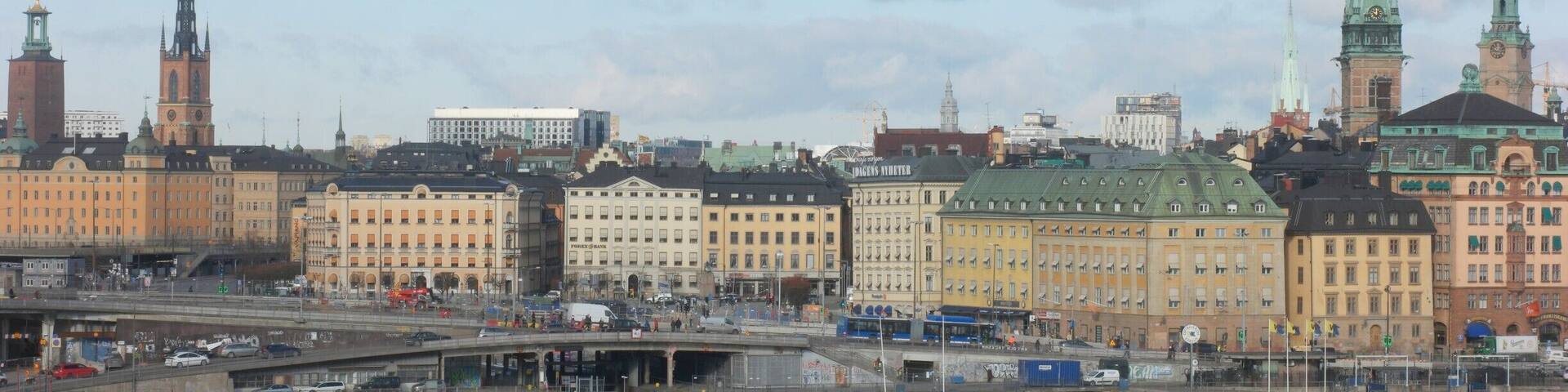 A cityscape with historic buildings, a river, and a bridge.
