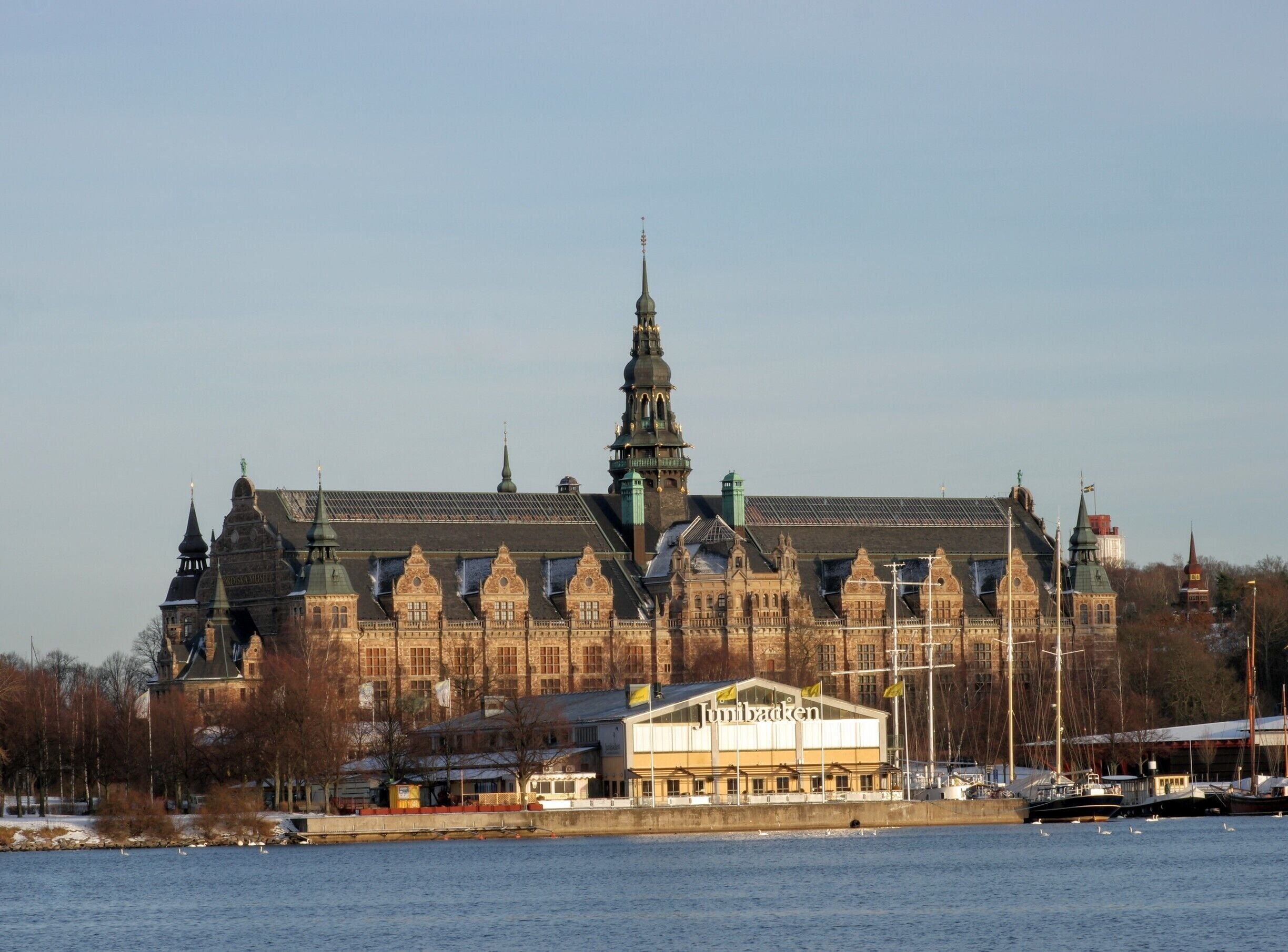 Behind Junibacken is the Nordic Museum (Nordiska museet).

Junibacken is a children’s museum, founded by Staffan Götestam, Fredrik Urström and Peder Wallenberg. It is situated on the island of Djurgården in the centre of Stockholm, Sweden. The museum was officially opened by the Swedish Royal Family on June 8, 1996. The museum is Stockholm’s 5th most-visited tourist attraction. The museum is devoted to Swedish children’s literature, but especially Astrid Lindgren. Outside the building is a bronze statue of Lindgren. 

- Wikipedia 
