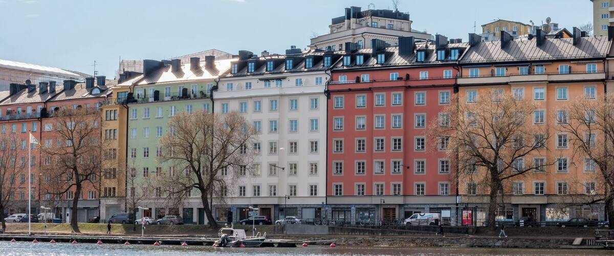 A row of colorful buildings along a river.