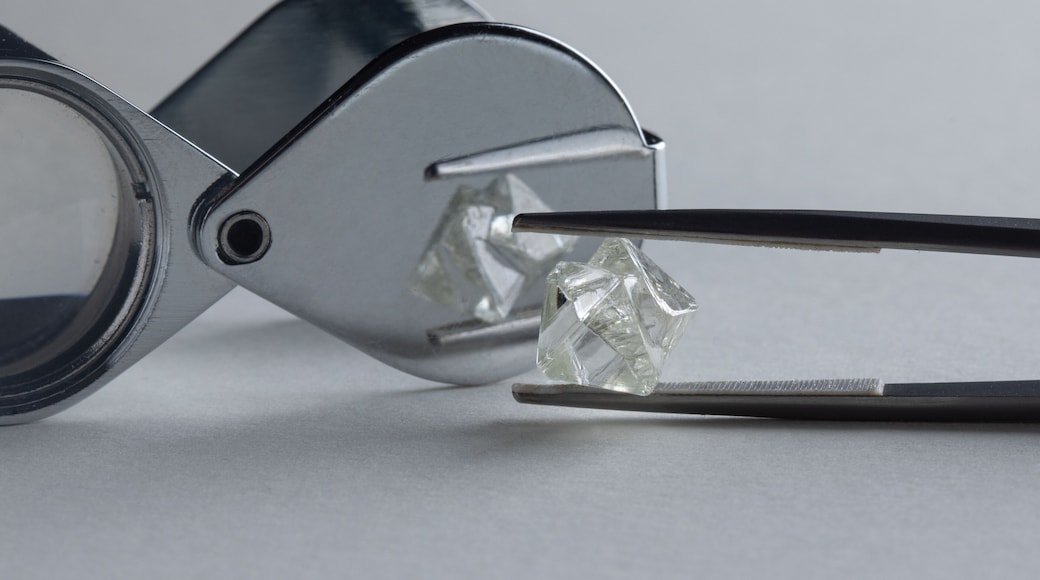 Rough diamond close up in the process of evaluation by diamond expert. High quality photo