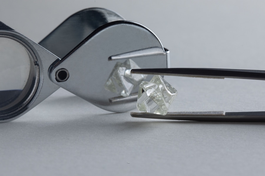Rough diamond close up in the process of evaluation by diamond expert. High quality photo
