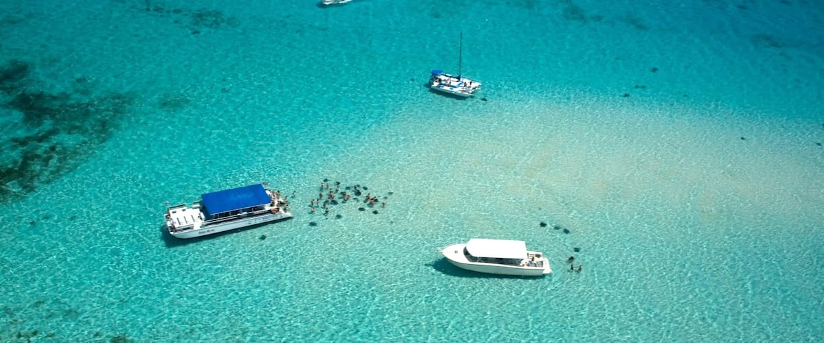 Cayman Islands which includes landscape views, tropical scenes and boating