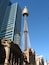 A modern cityscape with a distinctive tower and classical architecture.