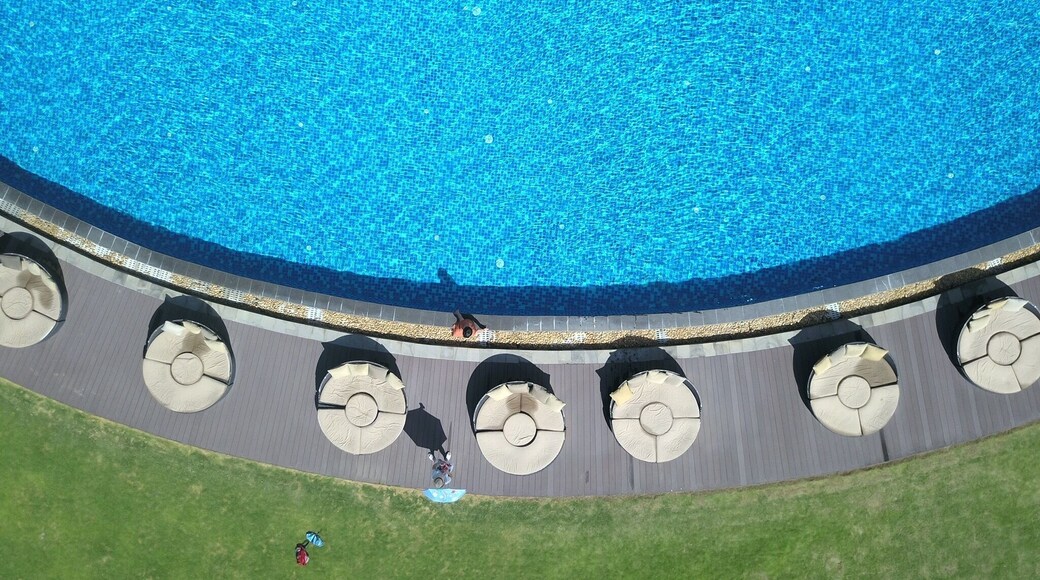 Birdview of swimming pool,it is about 100 meters away from the beach. The sun beam is too strong,no one in it,but some girls is taking photos.