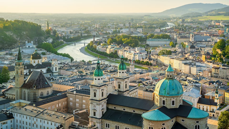 A cityscape with prominent domed buildings and a river.
