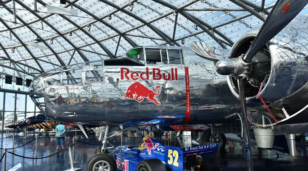 http://www.hangar-7.com/de/
Hangar-7 is a building in Salzburg, Austria, hosting a collection of historical airplanes, helicopters and Formula One racing cars, and serving as home for the Flying Bulls, an Austrian aviation team. Hangar-7 is owned by Red Bull founder Dietrich Mateschitz. It houses the Michelin starred restaurant Ikarus,two bars and a lounge. The building is airfoil shaped, constructed of 1,200 tons of steel and 75,000 sqft of glass surface