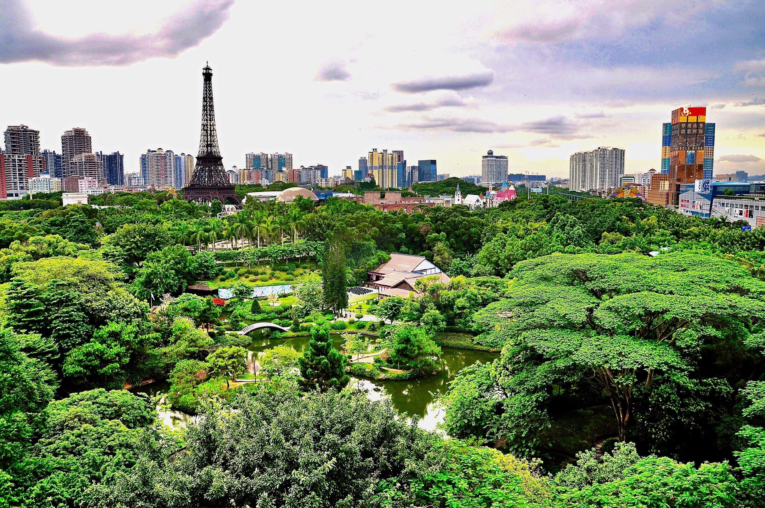 Looking west to the Window of the World (世界之窗) from my friend’s apartment in Shenzhen, Guangdong Province, China. It’s China Mainland’s second theme park after reform and opening up in 1979, and has about 130 reproductions of some of the most famous tourist attractions in the world squeezed into 48 hectares (118 acres). The 108 metre (354 ft) tall Eiffel Tower dominates the skyline and the sight of the Pyramids and the Taj Mahal all in proximity to each other are all part of the appeal of this theme park.
#China #Shenzhen #Guangdong #ThemePark #AboveItAll #WorldOfTheWorld