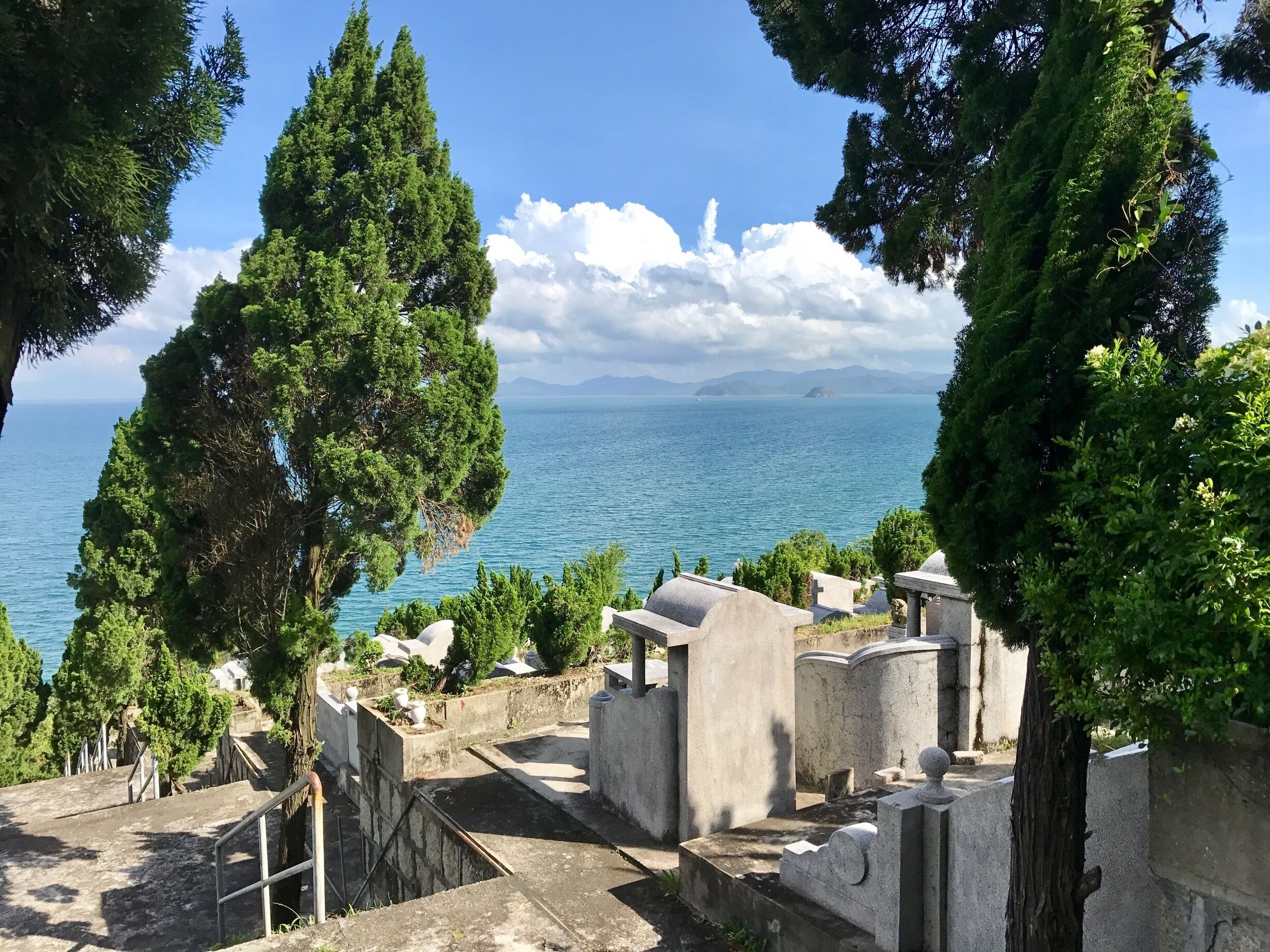 Huaqiao cemetery is definitely worth visiting. First of all it is a part of Chinese culture and you have to discover it if you wanna meet Chinese life as it is. Secondly, you will face absolutely unbelievable sea view from here! 
Take bus M362 or E26 to get here. Stop is called "Huaqiao Cemetery" (bus routes often change in Shenzhen, so better use a map before coming here)