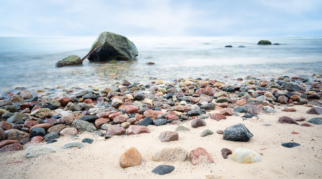 A view of the rocky beach in Miedzyzdroje. Baltic sea. Stones into the water. Blurry effect with long exposure.