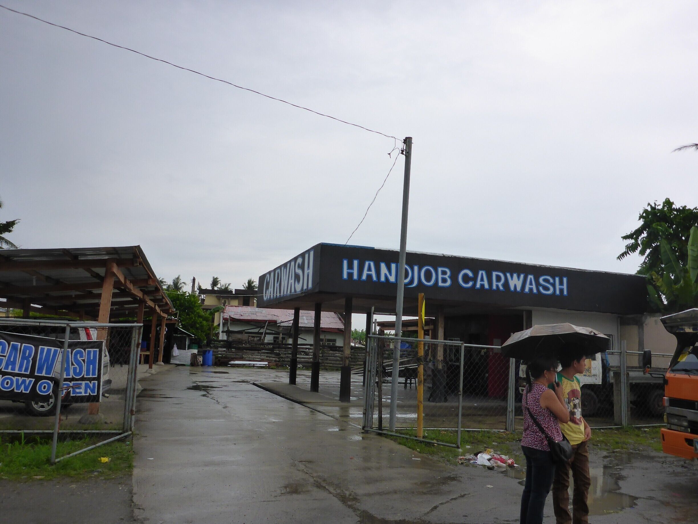 Along the National Highway in Tacloban, Leyte.  Mechanization and electricity are expensive, labor is not.

So what else would you call a car wash done by hand?  Anything but this.