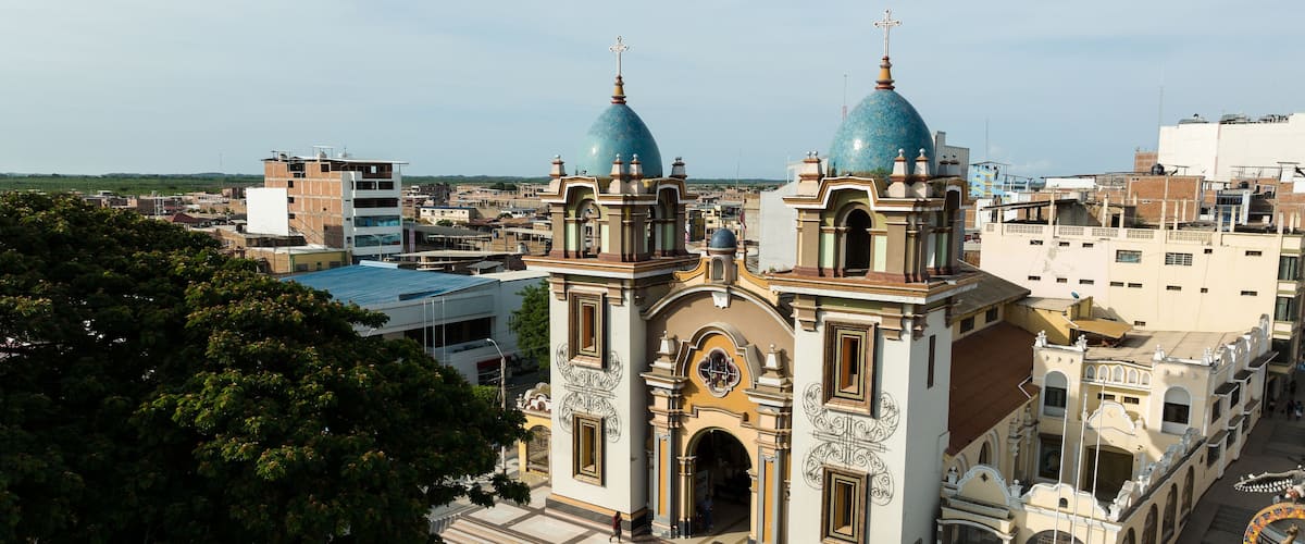 A church with two blue domes and ornate architecture.