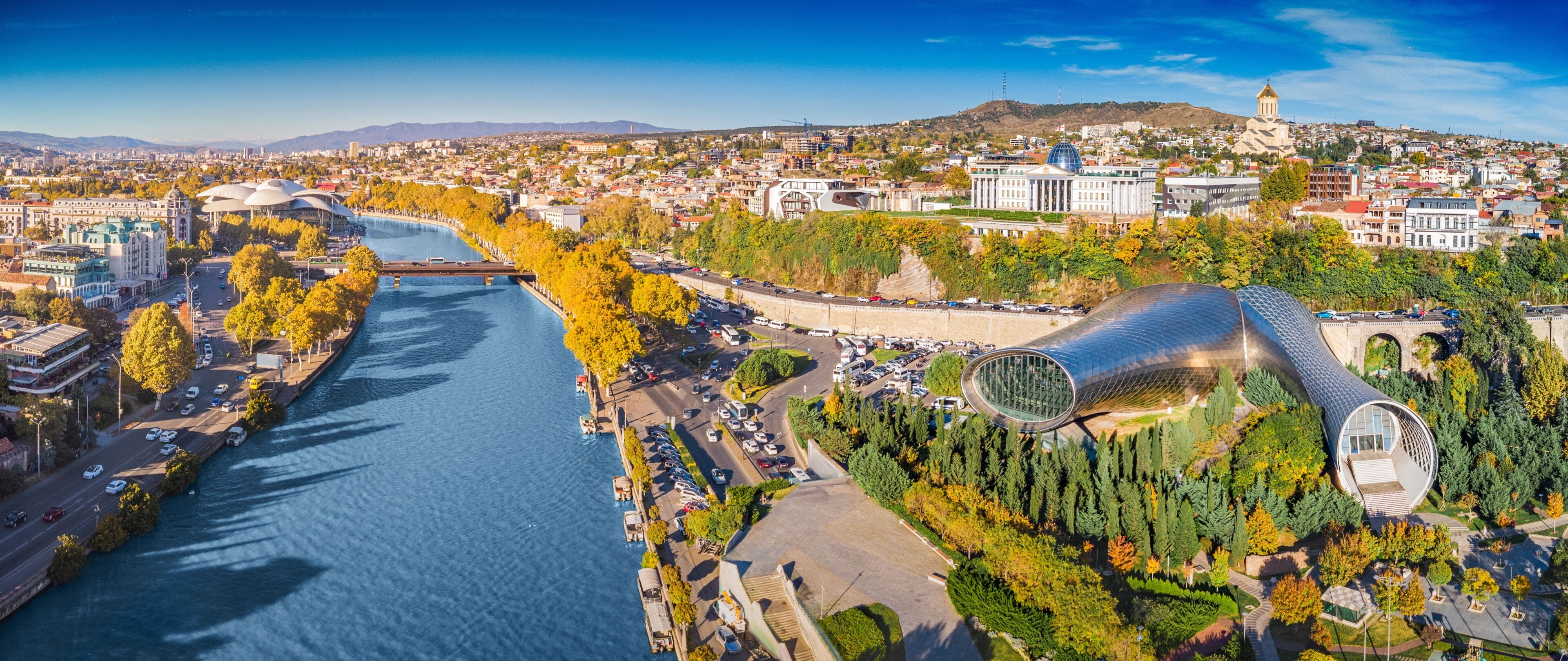 Aerial view of Tbilisi showing the Kura River, modern architecture