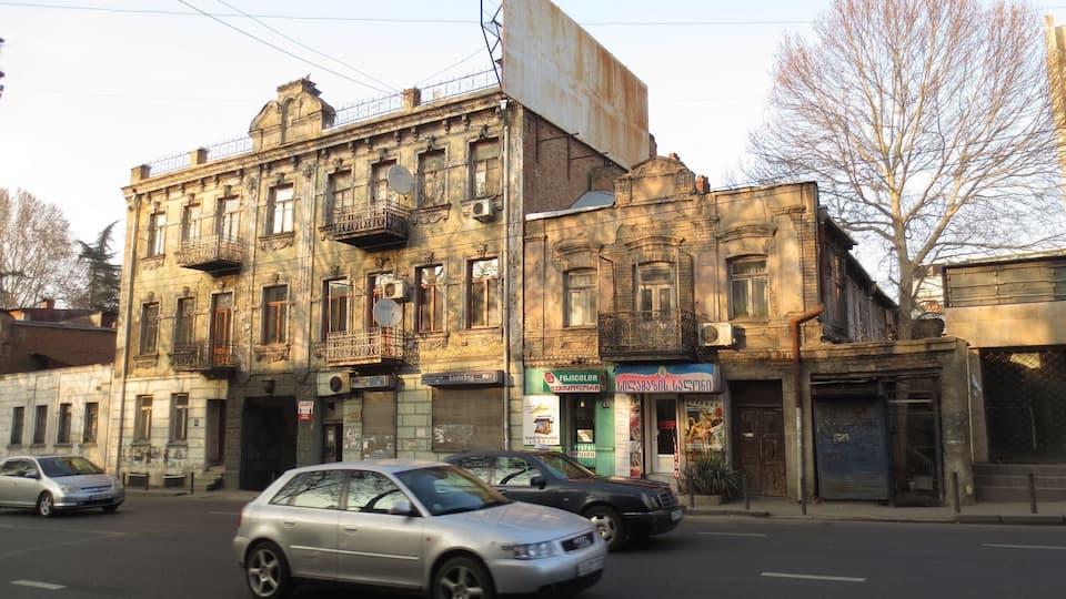 #architecture http://tinyurl.com/lnjfapv This building is one of my favorites in the city of Tbilisi, Georgia.
While I don't know much about architecture, I believe that this building is one of the few and dwindling examples of Art Nouveau architecture that remain in Tbilisi.
The top of this building features a date of 1912, and there's a number of frescoes and interesting masonry work on the outside. The building literally looks like it is rusting away.
Link is to an article about Art Nouveau architecture in Tbilisi.