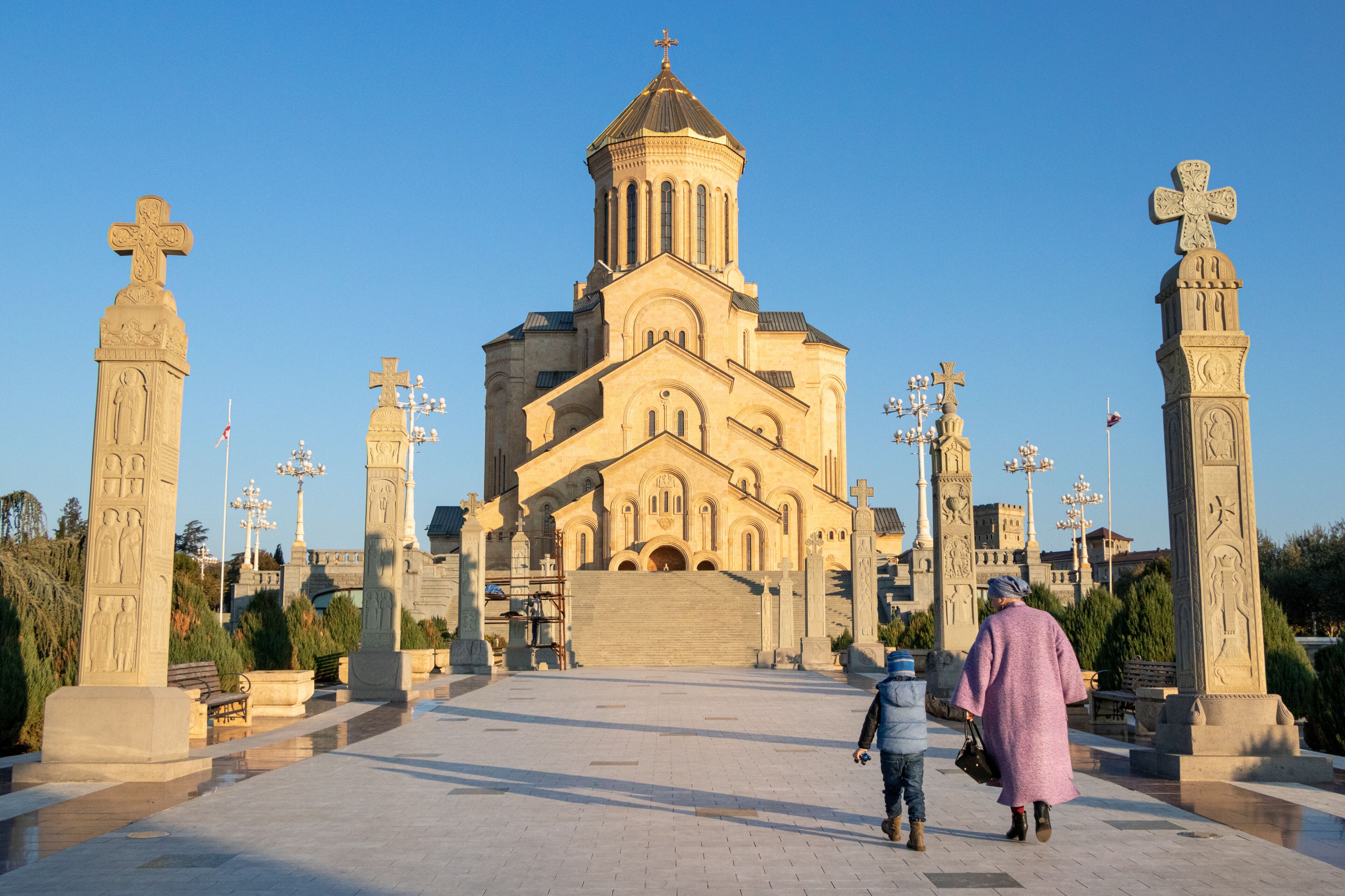 Mother and Son Walking on Path Toward Holy Trinity Cathedral in Tbilisi, Georgia