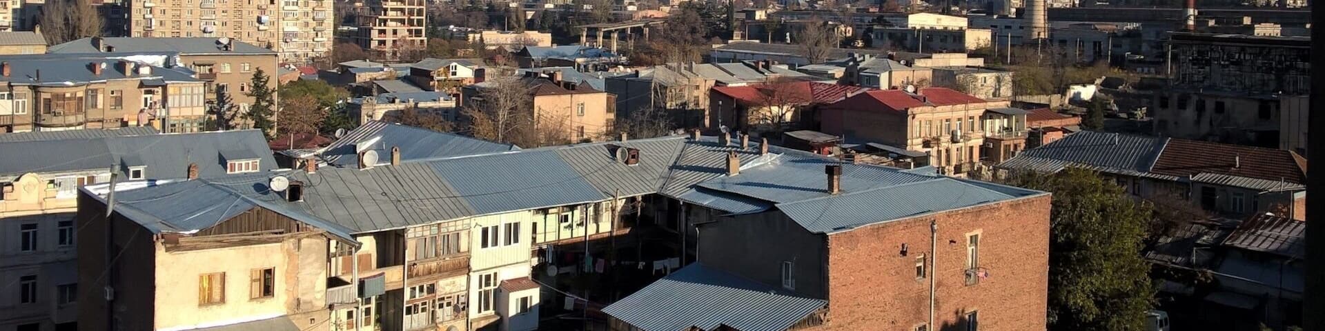 View from the city of Tbilisi on a crisp and cool November morning. A light dusting of snow is visible at the top top of the hills rising above the northern portion of the city.