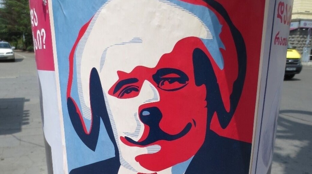 Spotted on a pole in the city of Tbilisi, Georgia. This was at the entrance to Vake Park.
I believe that it says "insurance" under the dog faced man.