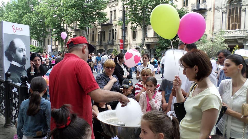 Man making cotton candy - view from the city of Tbilisi on Georgian Independence Day.