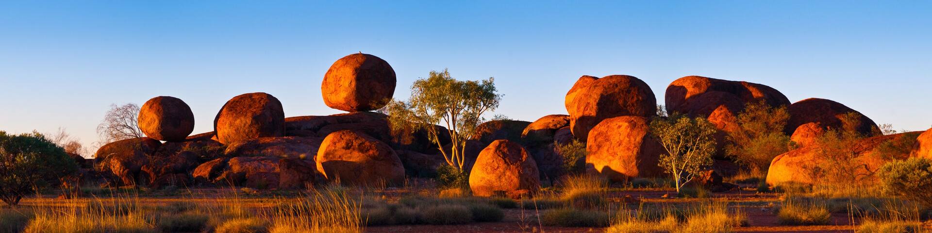 Devil's Marbles, Australia. The Devils Marbles are an extensive collection of red granite boulders in the Tennant Creek area of Australia's Northern Territory