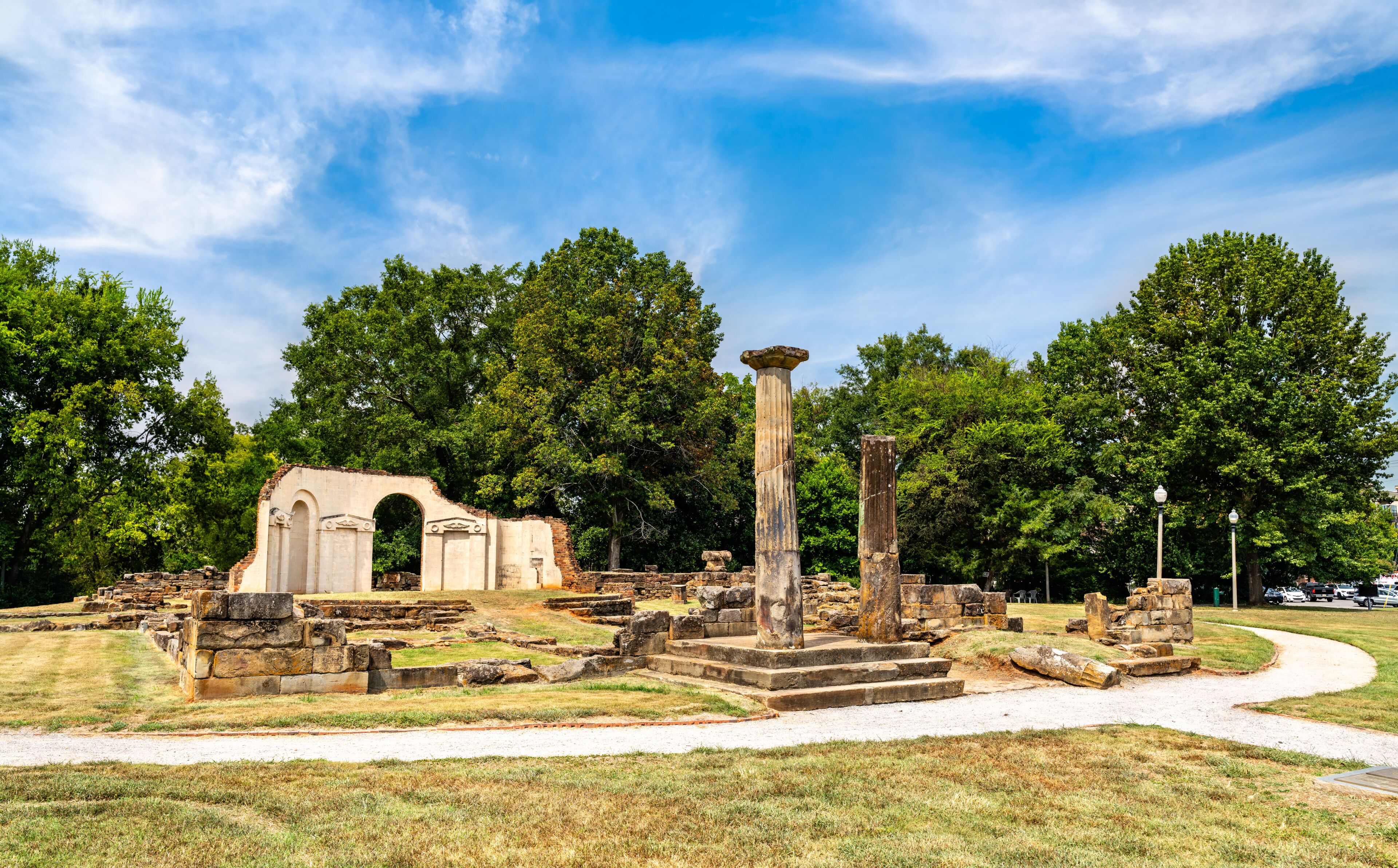 Old Alabama State Capitol ruins in Tuscaloosa. Historic site features stone columns and foundation remains in Capitol Park under a blue sky