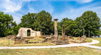 Old Alabama State Capitol ruins in Tuscaloosa. Historic site features stone columns and foundation remains in Capitol Park under a blue sky