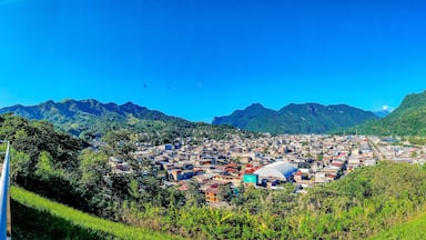 A town nestled in a valley with mountains in the background.