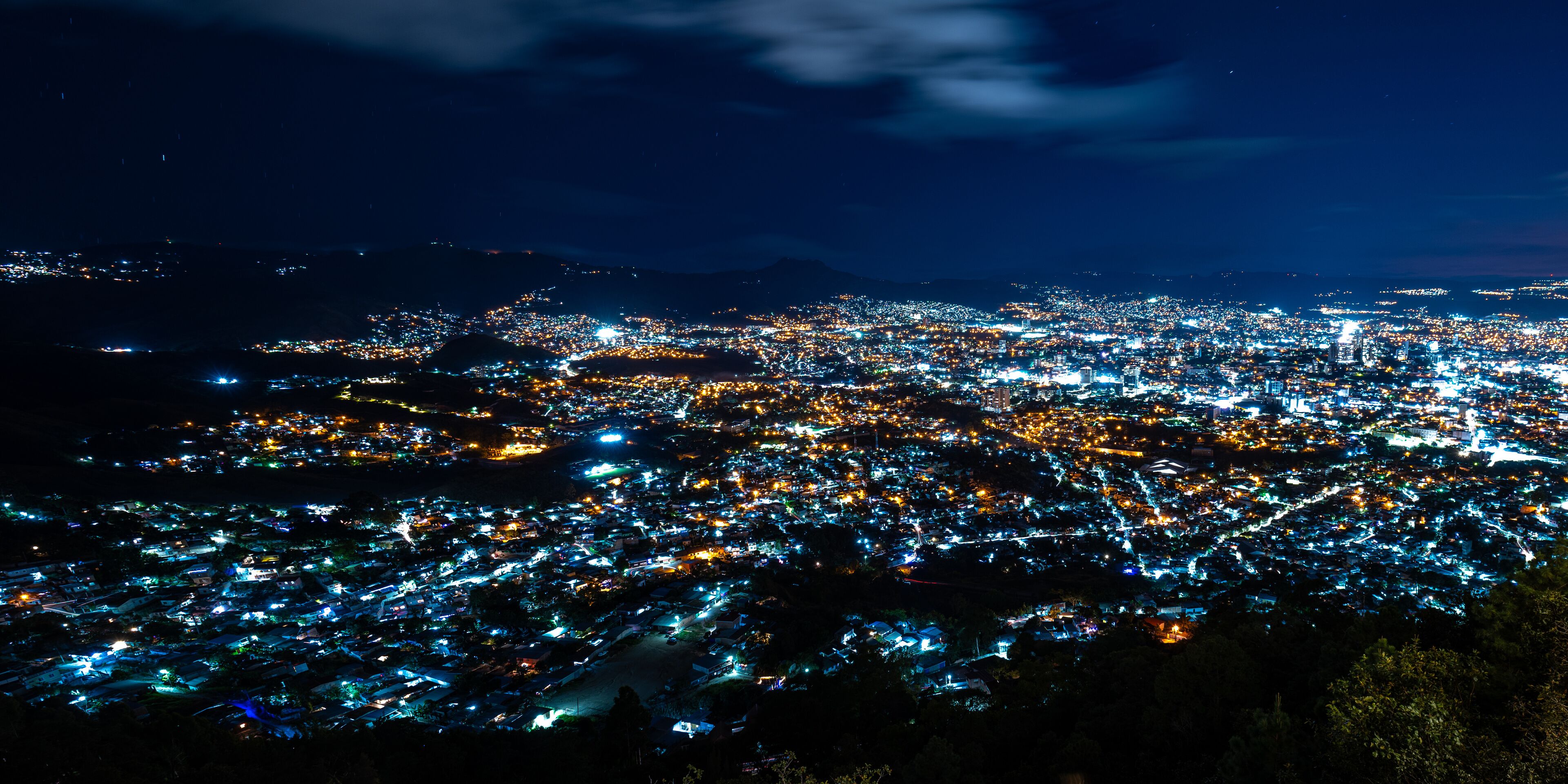 Wide Panoramic Colorful Tegucigalpa Night Cityscape Long Exposure Shot With Blurred Clouds