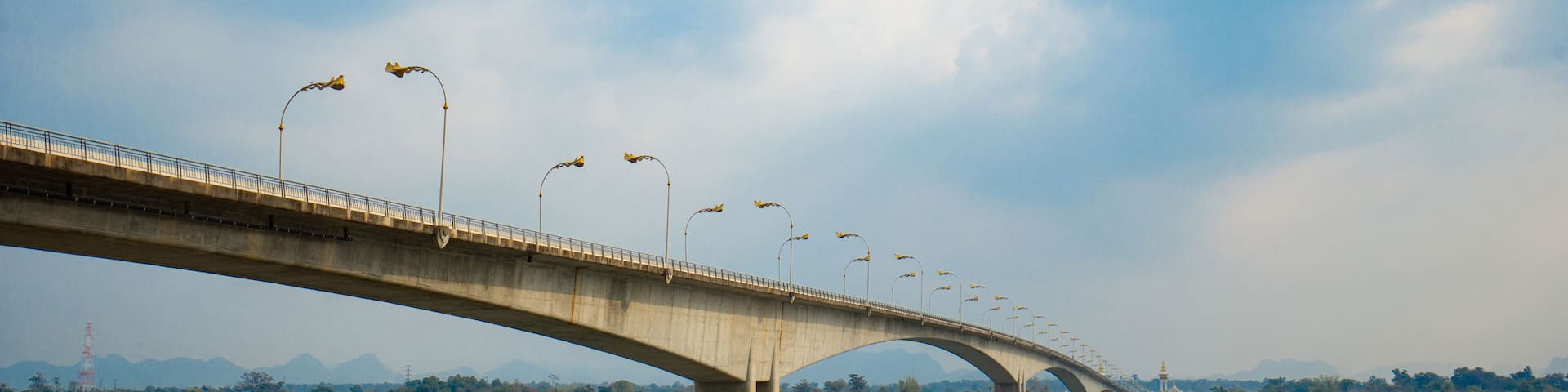 Third Thai–Lao Friendship Bridge, is a bridge over Mekong river that connects Nakhon Phanom Province in Thailand with Thakhek, Khammouane in Laos in cloudy blue sky day