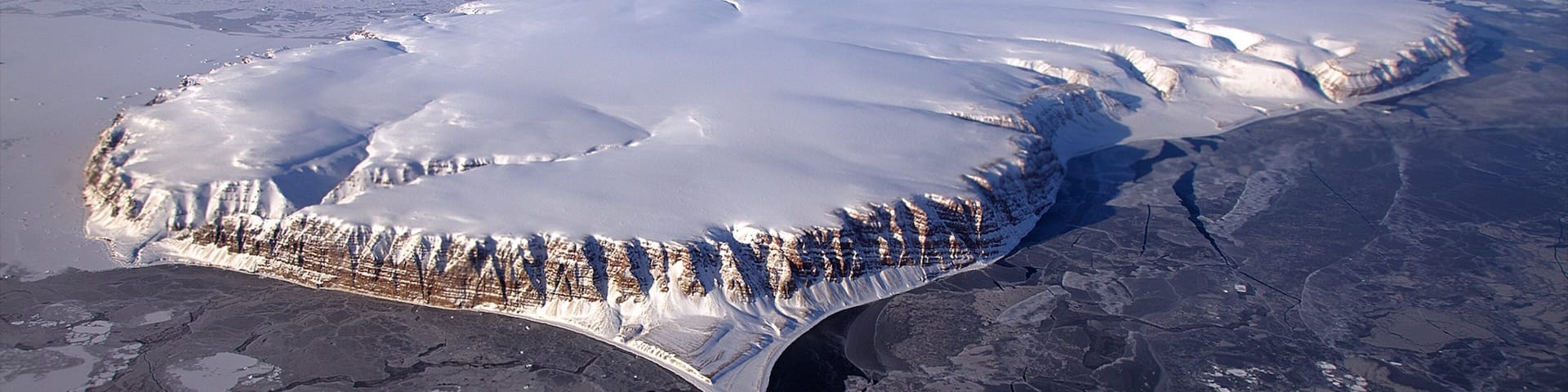 Qaanaaq featuring island views and snow