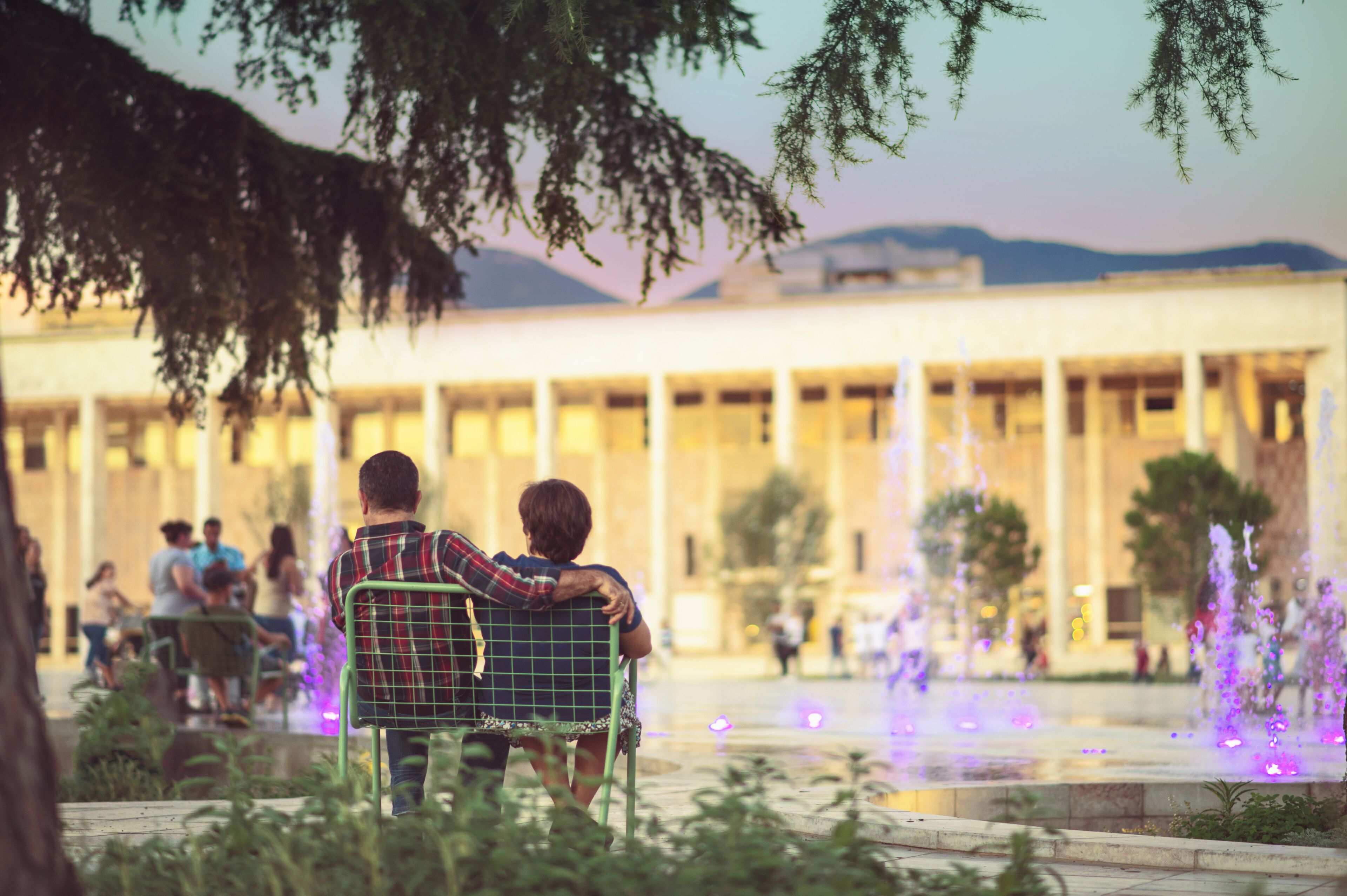 Old couple enjoying the evening city in Tirana center at newly rebuilt Skanderbeg Square