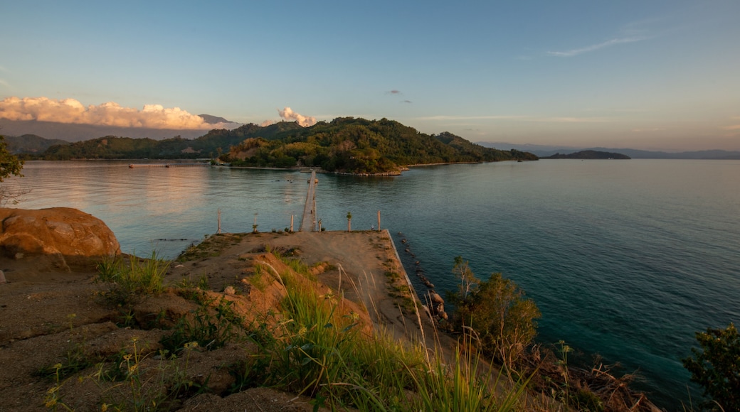 Sunset on a bridge connecting sulawesi main island and sabang tende island, tolitoli, central sulawesi, indonesia with visible rock and coral