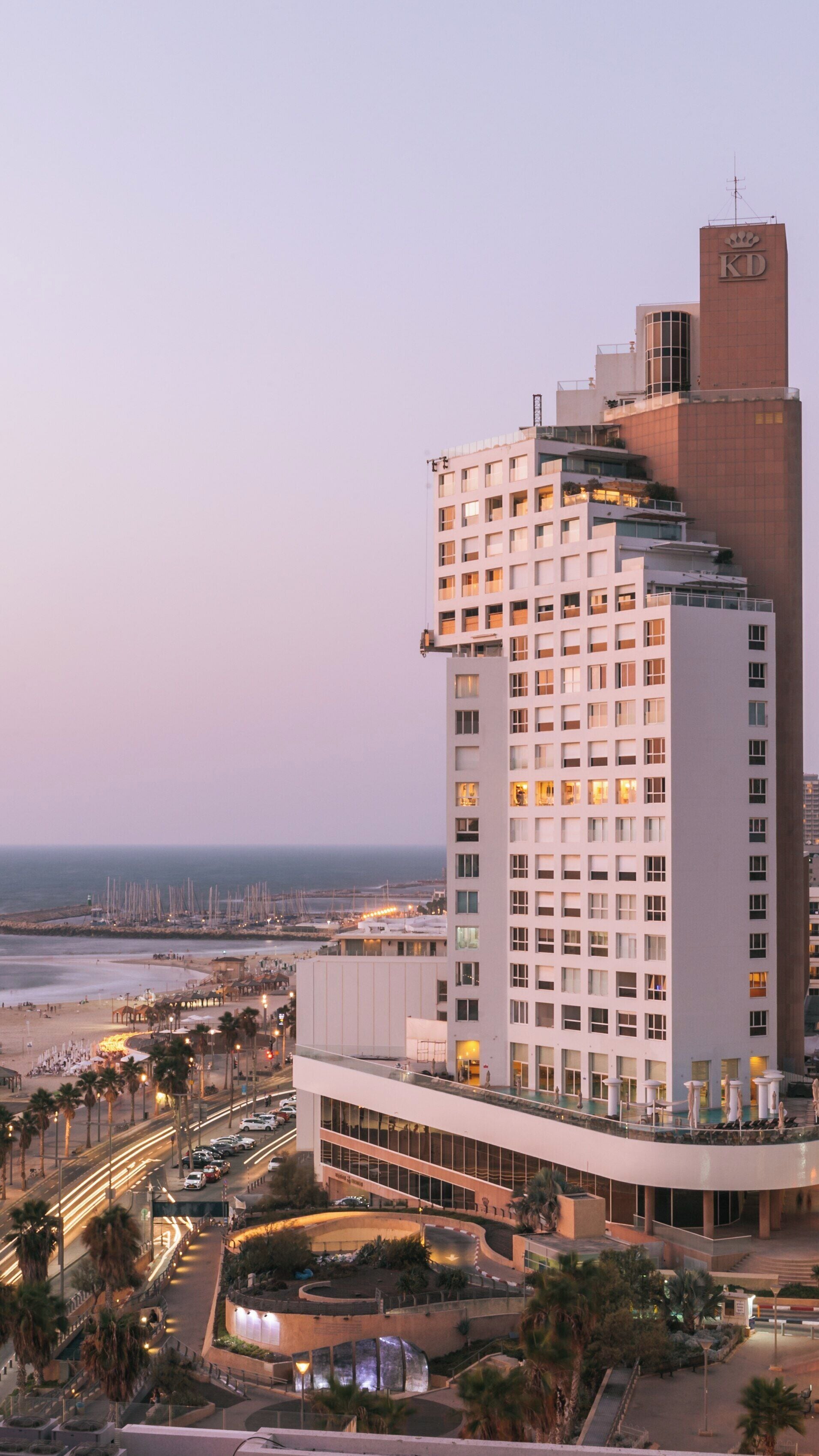 Frishman Beach at sunset with a view of the Tel Aviv Promenade and elegant high-rise buildings in Israel