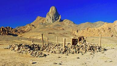 April 2011
Ilaman, Ahaggar mountains, Sahara
Ahaggar or Hoggar mountains are the rockiest and highest part of Sahara desert some 1.500 km down from Algeria coast. It is mostly highland plateau with altitude of 2.000 metres made of volcanic material ca. 2 million years old. In some places there are the remaining spikes of volcanic cones rising like the one called Ilaman with its appealing peak 2.760 m high. Water and wind eroded the surface to strangely beautiful stones of all sizes, shapes and colour shades.
The structure in front is a simple sanctuary of local Touareg people. The name Touareg means "forgotten by God" and they were titled so by the more orthodox muslims in the past. They practice the islam faith but in their way... No fancy mosques in the desert, just small structures made of stone and wood..
Make a round trip from Tamanrasset with friendly local agencies to see it!
#sahara