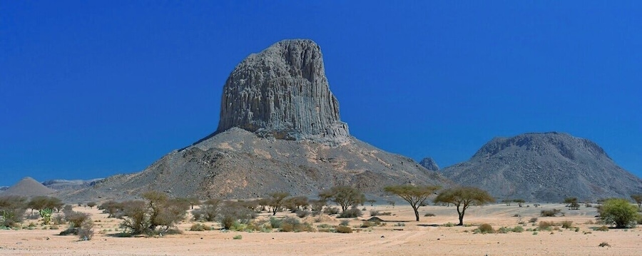 April 2011
Iharen peak or Pic Lapperine, Ahaggar mountains, Sahara, Algeria
Iharen is a beautiful volcanic scoria cone peak near Tamanrasset en route to Assekrem in Ahaggar mountains in Central Sahara. Its altitude is 1.732 metres and its second name is after French general who lived and died in Sahara in 1920. Actually Tamanrasset was originally named Fort Lapperine. Iharen is popular spot for climbers however just the view from below is amazing.