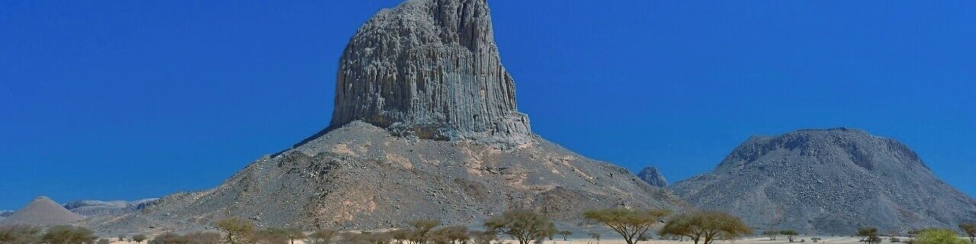 April 2011
Iharen peak or Pic Lapperine, Ahaggar mountains, Sahara, Algeria
Iharen is a beautiful volcanic scoria cone peak near Tamanrasset en route to Assekrem in Ahaggar mountains in Central Sahara. Its altitude is 1.732 metres and its second name is after French general who lived and died in Sahara in 1920. Actually Tamanrasset was originally named Fort Lapperine. Iharen is popular spot for climbers however just the view from below is amazing.